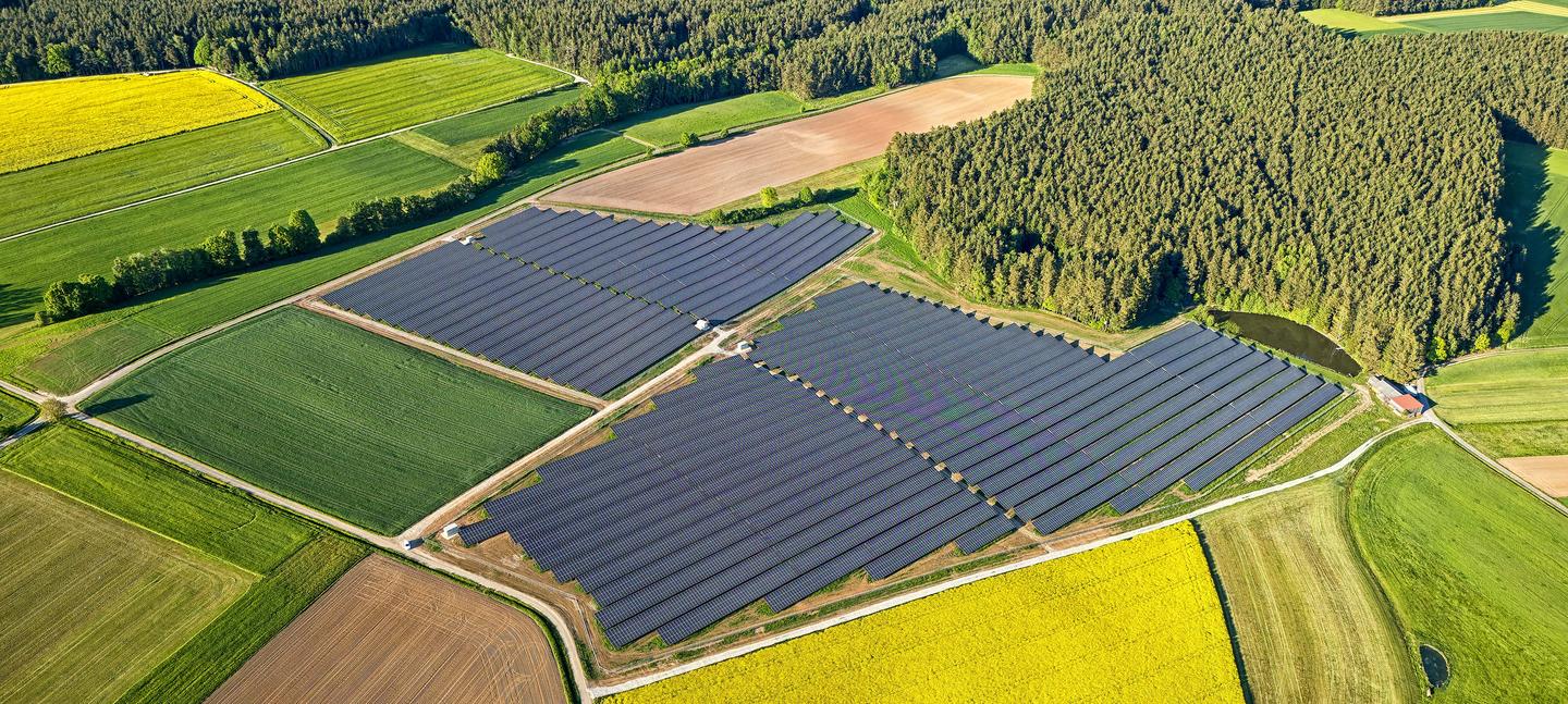 Luftaufnahme eines Solarparks zwischen Feldern